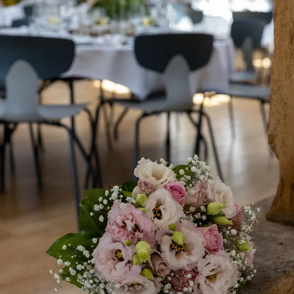 Pink and white bouquet resting on a wedding table